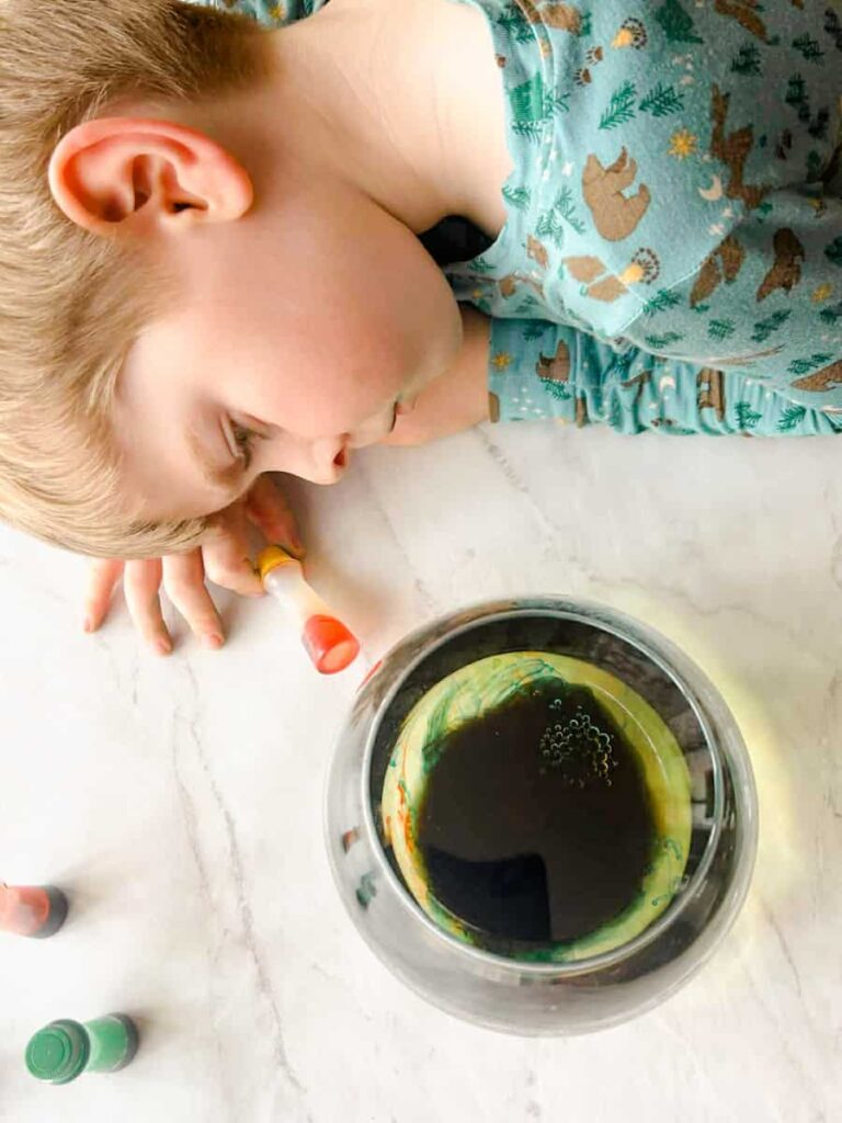 child looking at the fireworks in the jar