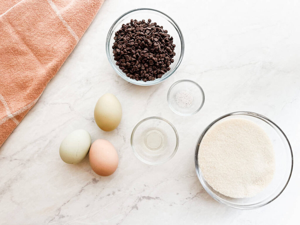 eggs, vinegar, salt, sugar and mini chocolate chips sitting on the counter
