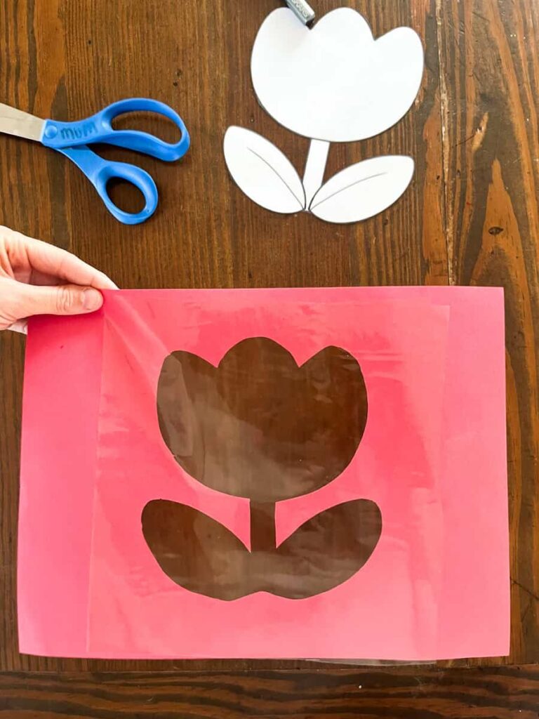 contact paper covering the tulip frame next to scissors and tulip template