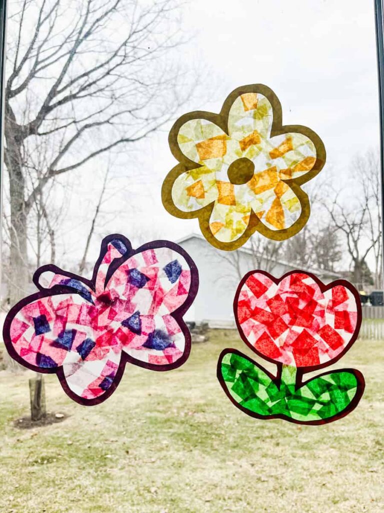 butterfly sucatcher, flower suncatcher and tulip suncatcher hanging on a window