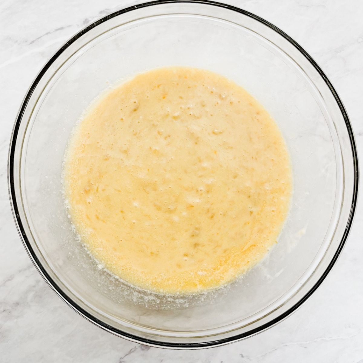 Wet ingredients in a bowl on the counter.