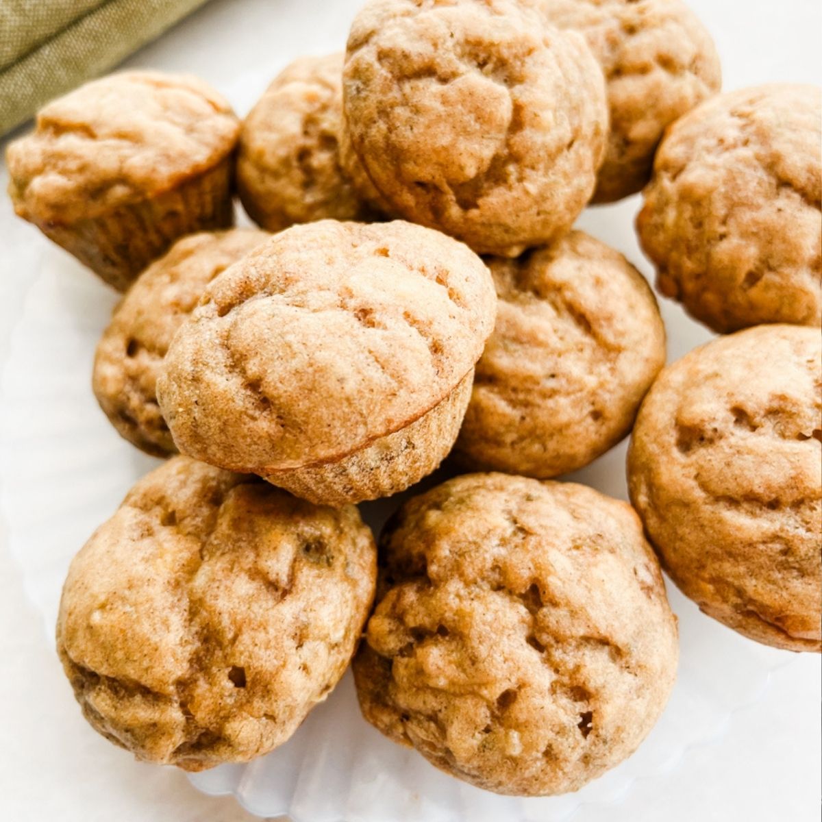 Plate full of banana mini muffins sitting on the counter.