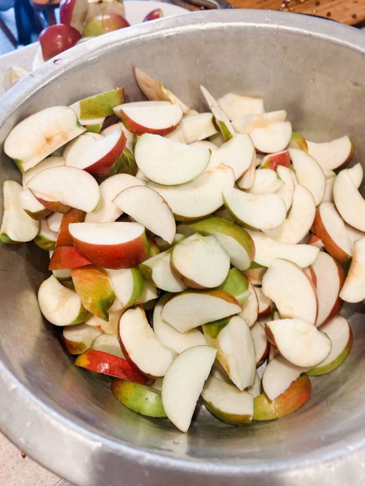 apples in a large bowl cored and sliced.