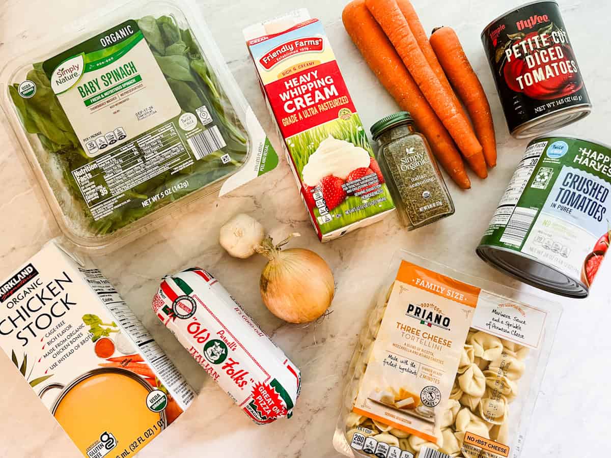 Ingredients for crockpot tortellini soup on the counter.