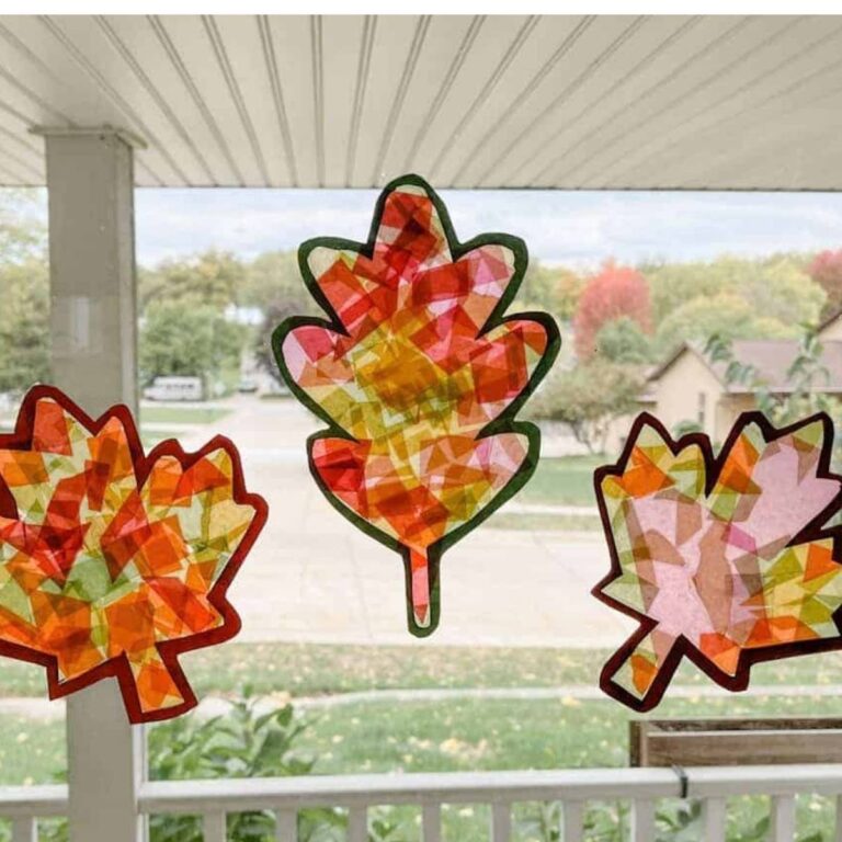 3 completed leaf suncatchers hanging in window.