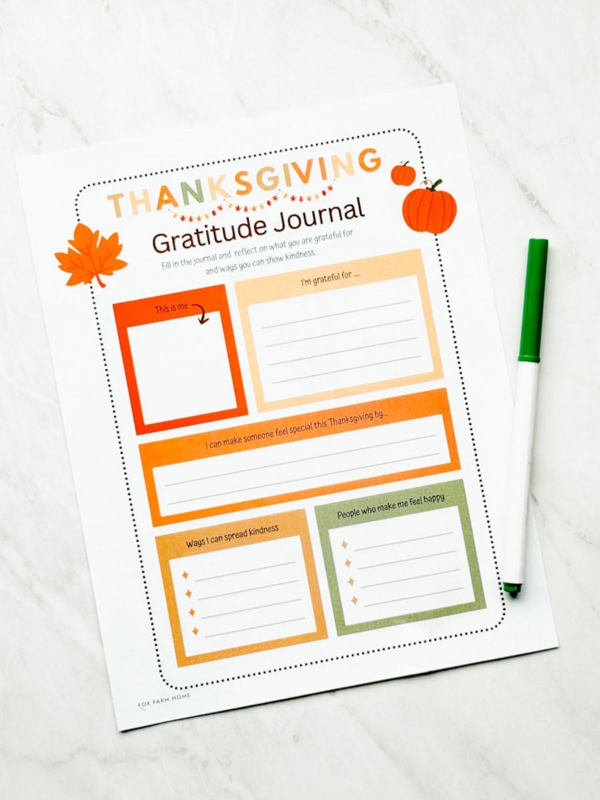 Printable Thanksgiving gratitude journal on table with green marker next to it on table.