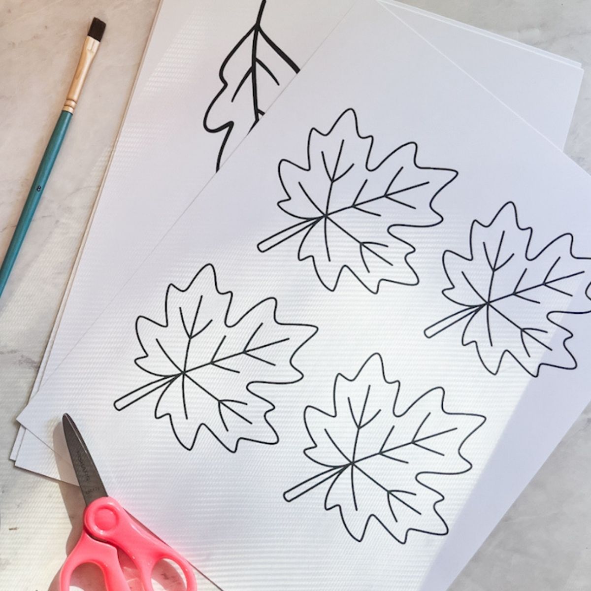 Printed leaf templates next to a pair of scissors.